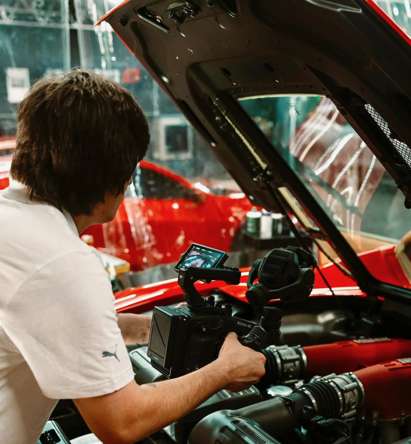 Max filming into the engine bay of a Ferrari